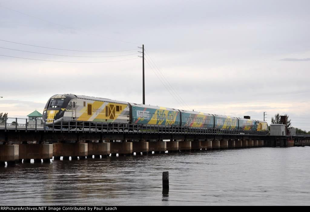 Southbound Brightline eases across the bridge